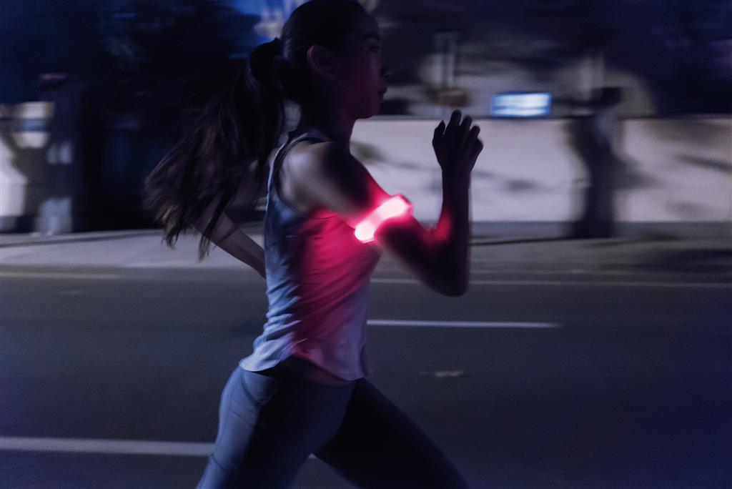 photo of woman running at night using the safety running LED band